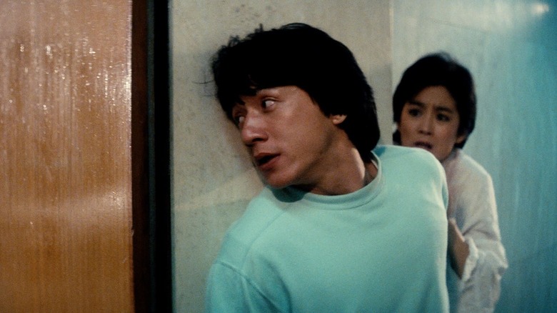 Chan Ka-Kui stands against a wall in "Police Story"