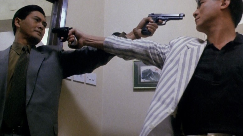 Chow Yun-Fat faces a gun