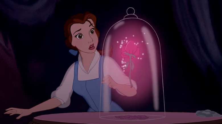 Belle looks at magic rose