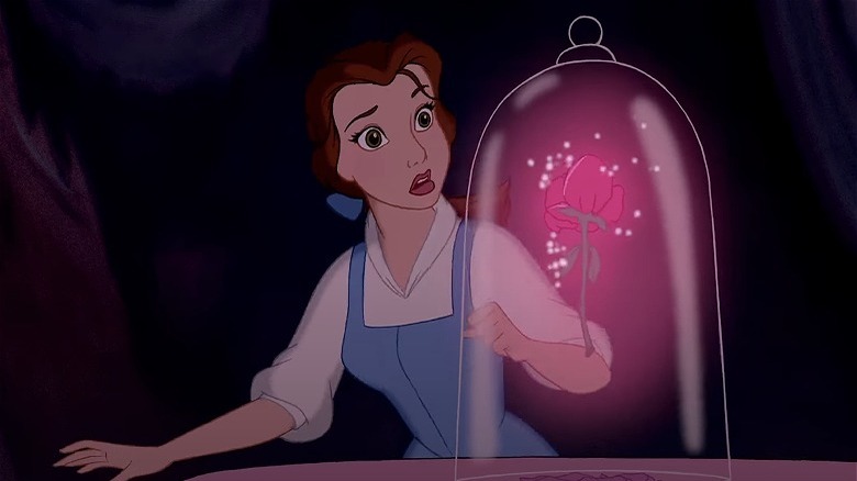 Belle looks at magic rose