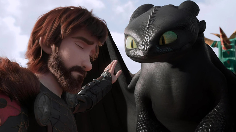 Adult Hiccup reaching out to touch Toothless