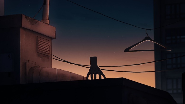 Severed hand sitting on rooftop during sunset