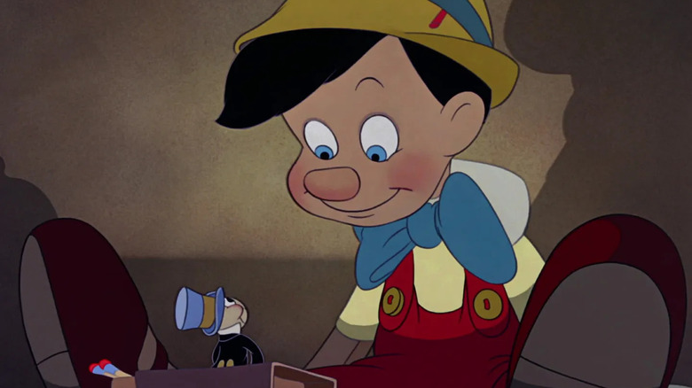 Pinocchio talking to Jiminy Cricket