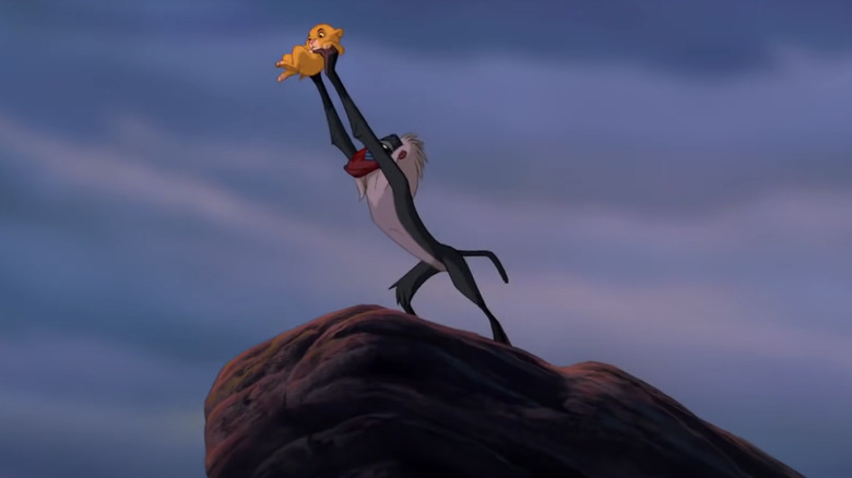 Rafiki holds up newborn Simba