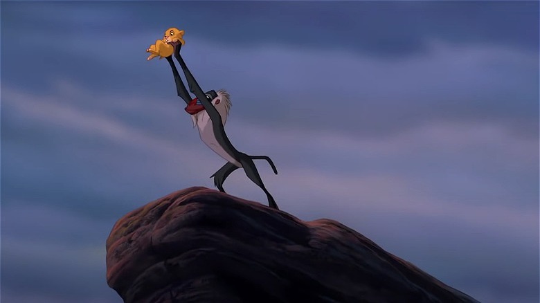 Rafiki holds up newborn Simba on Pride Rock (1994)