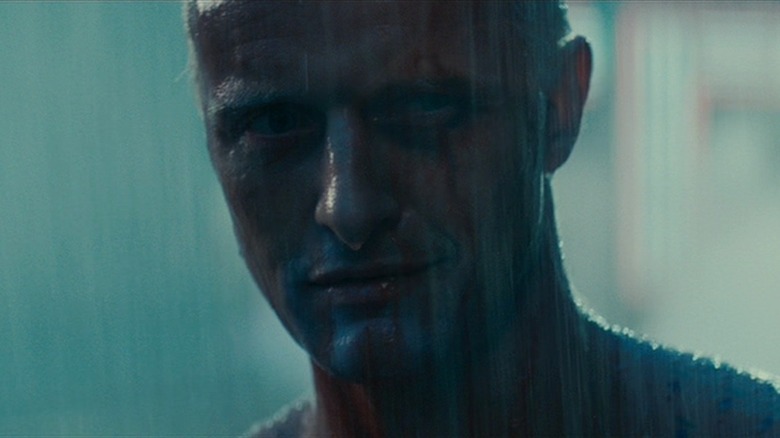 Roy Batty stands in rain