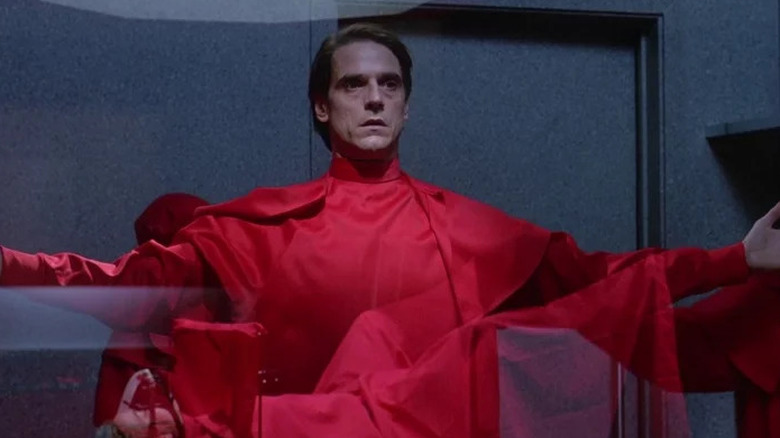 Jeremy Irons holds out arms