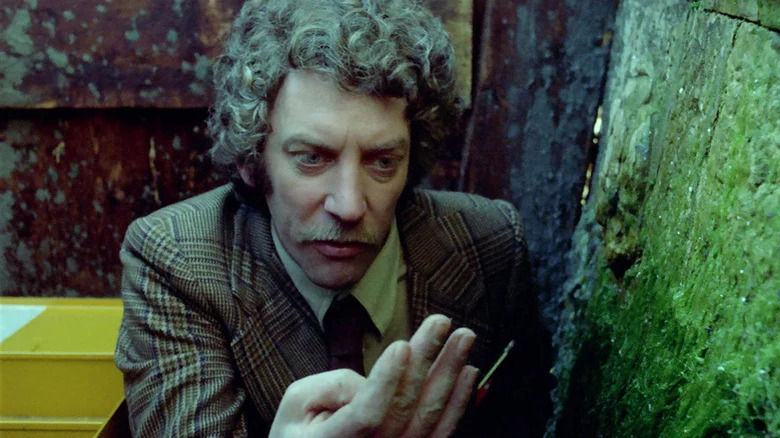 Donald Sutherland inspects his hand