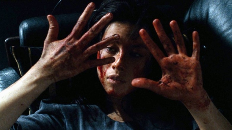Mylène Jampanoï looks at bloody hands