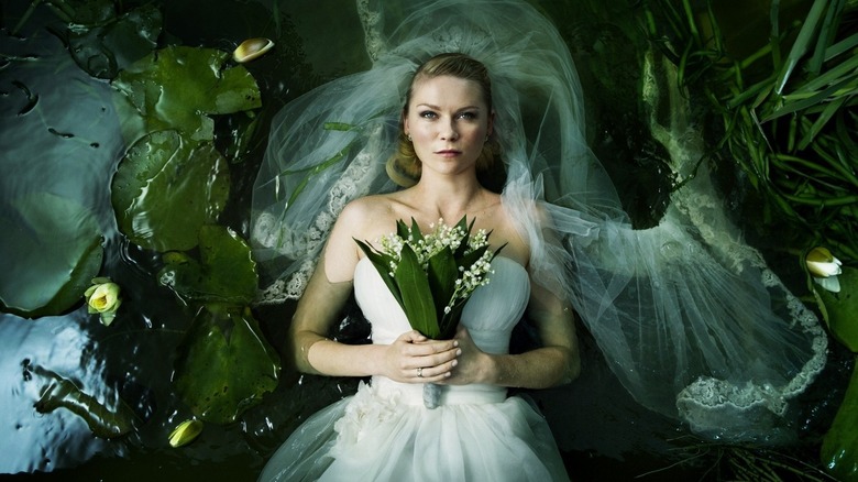 Kirsten Dunst lays in pond with flowers