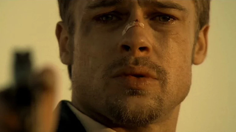 Teary Brad Pitt holds gun