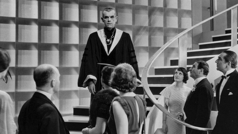 Boris Karloff looks at crowd from stairs