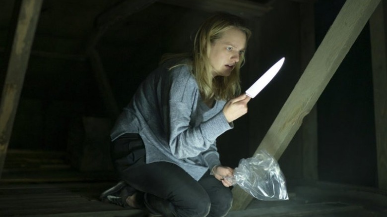 Elisabeth Moss holds knife