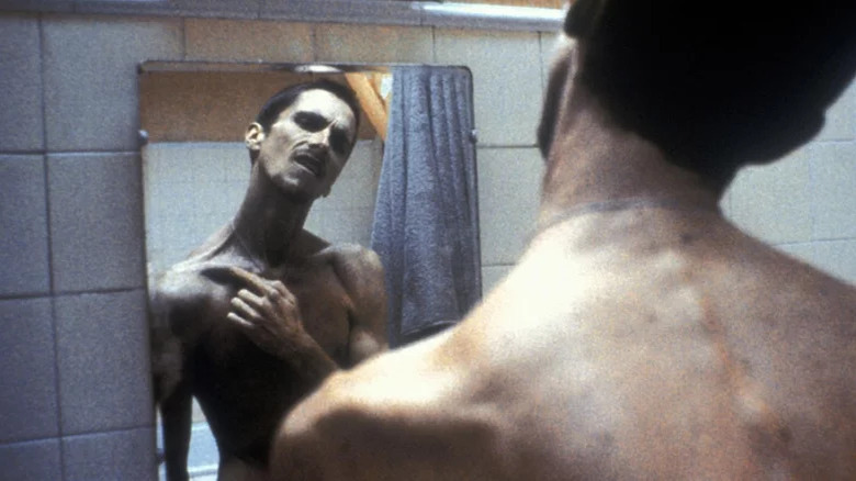 Gaunt Christian Bale looks in mirror
