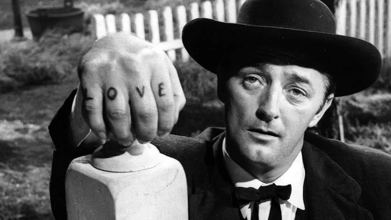 Robert Mitchum holds banister