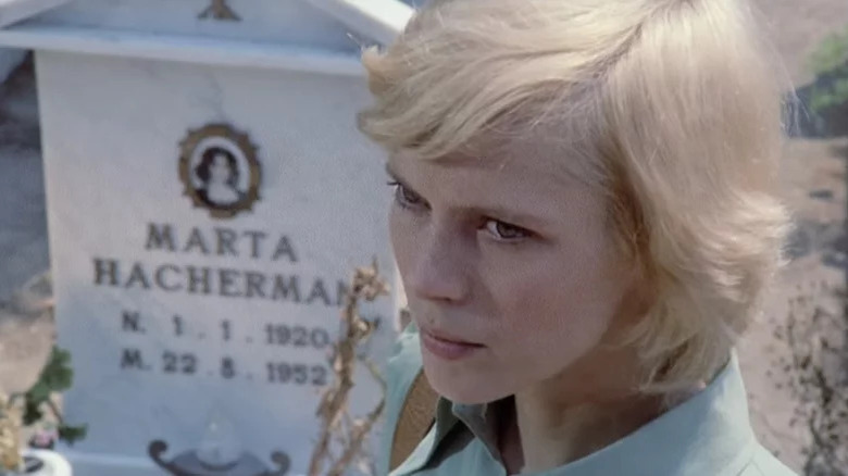 Mimsy Farmer looks up near gravestone