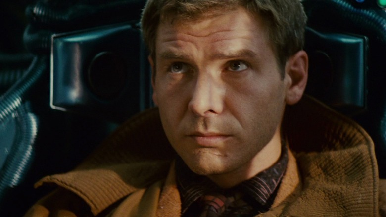 Harrison Ford as Rick Deckard taking a ride in a cab in Blade Runner