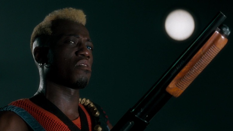 Simon Phoenix (Wesley Snipes) brandishes a shotgun in Demolition Man