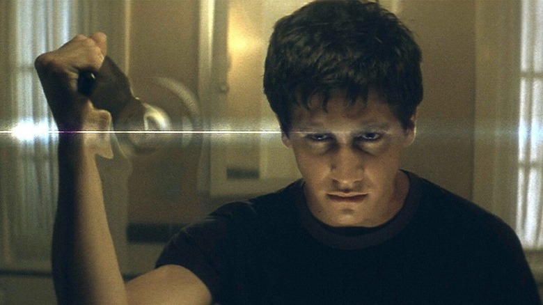 Donnie Darko presses against the dimensional barrier with a kitchen knife