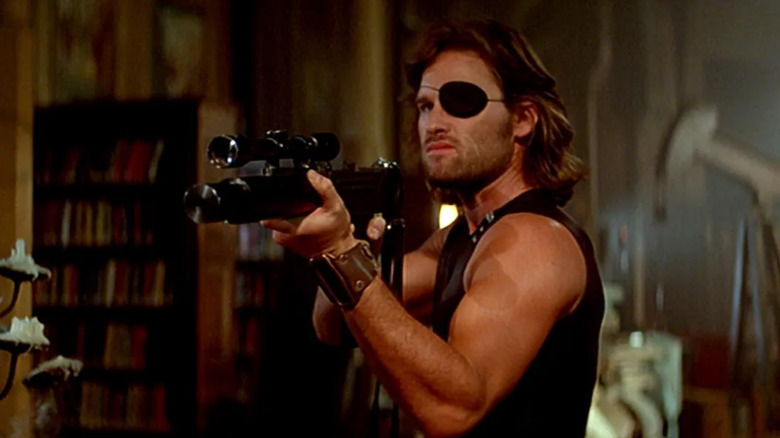 Snake Plissken aims a rifle in Escape from New York