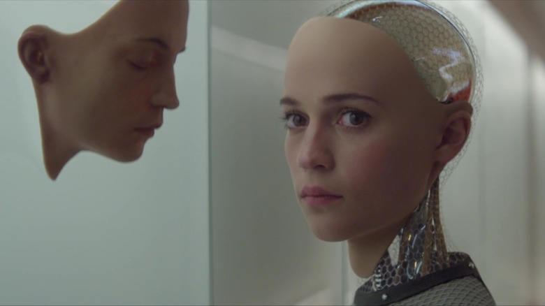 Ava (Alicia Vikander) examines an unused android face in Ex Machina