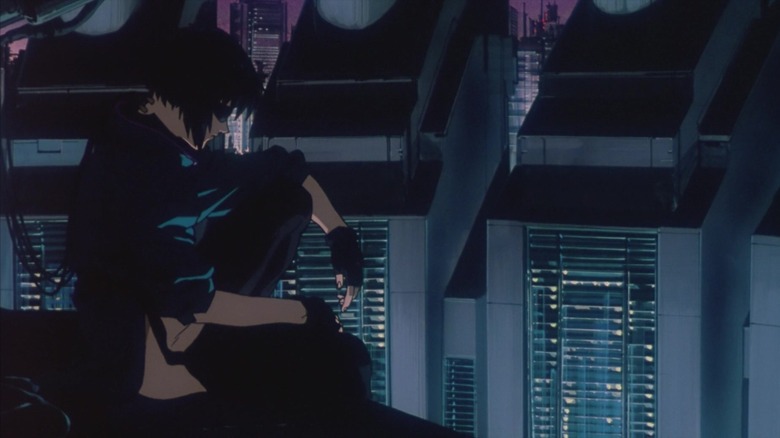 Major Kusanagi sits atop a building at the beginning of Ghost in the Shell