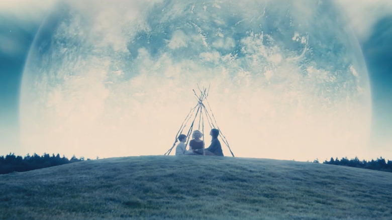 Kirsten Dunst, Charlotte Gainsbourg, and Cameron Spurr wait for the planet Melancholia to impact Earth