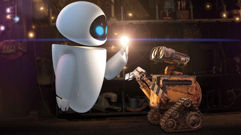 EVE lights up a light bulb in front of WALL-E