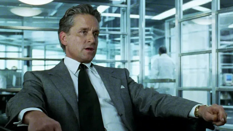 Michael Douglas sits in an office