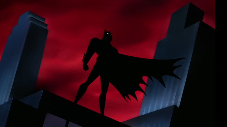 Batman silhouetted on rooftop