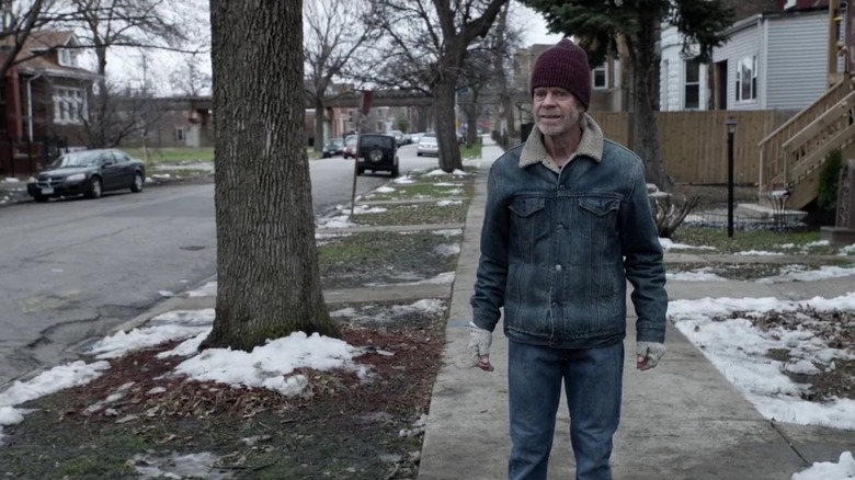 Frank Gallagher standing on sidewalk