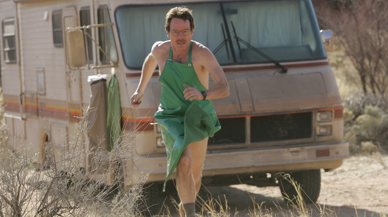 Walt running in the desert while wearing a green apron