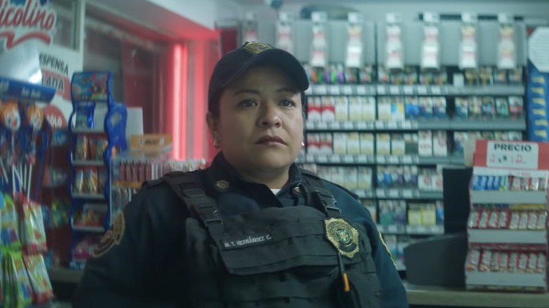 Monica Del Carmen standing in gas station in A Cop Movie