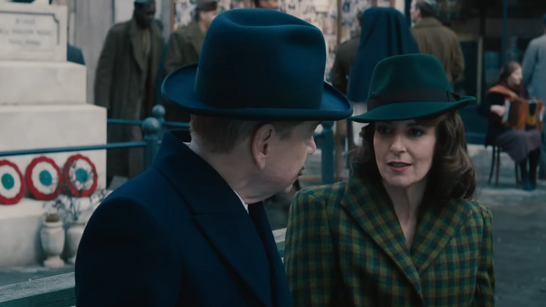 Ariadne Oliver wearing green hat and plaid coat