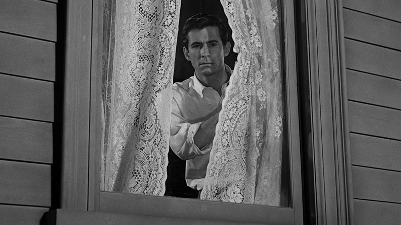 Norman Bates behind lace curtains