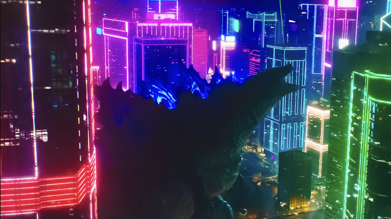 Godzilla surrounded by the illuminated buildings of Tokyo