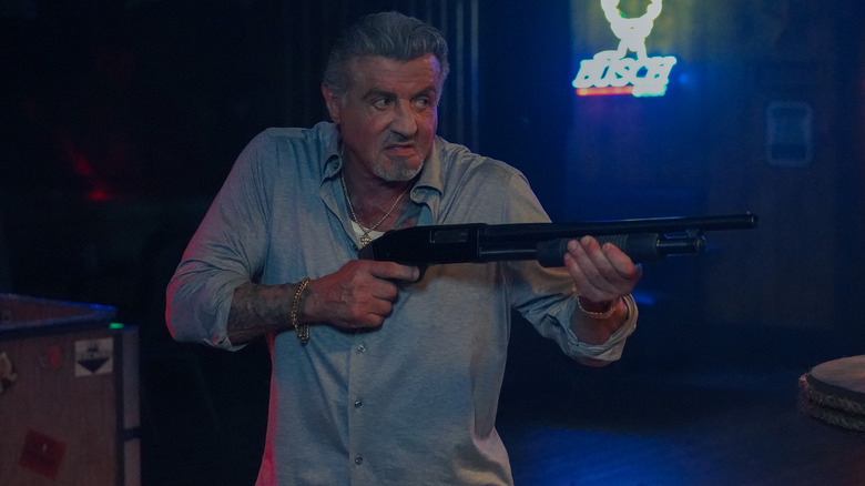 Sylvester Stallone holding a gun