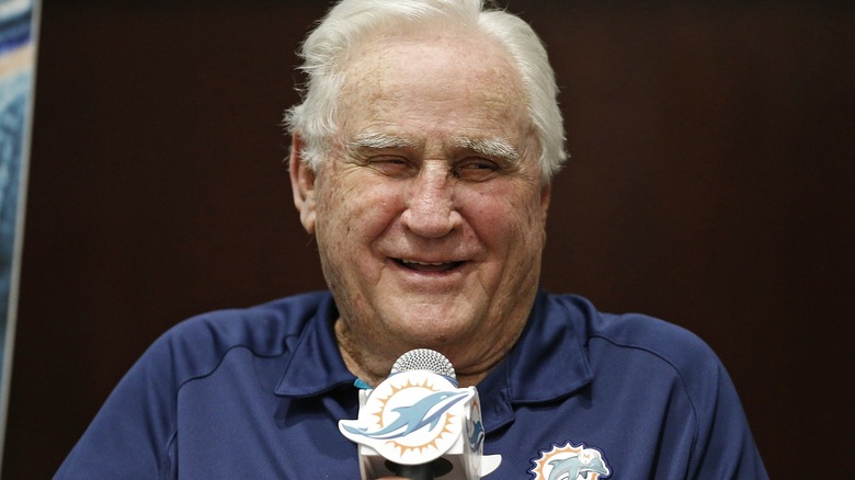 Don Shula holding microphone