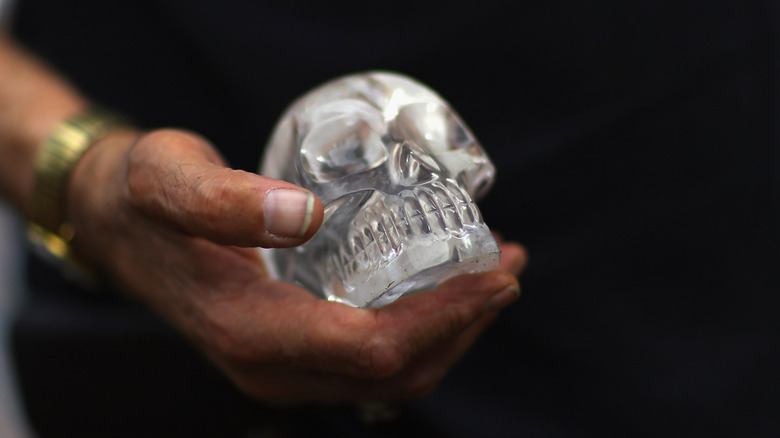 Man holds a crystal skull