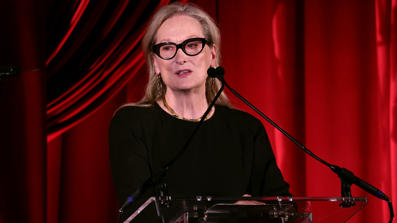 Meryl Streep in front of red curtains