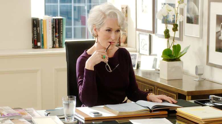 Miranda Priestly biting glasses