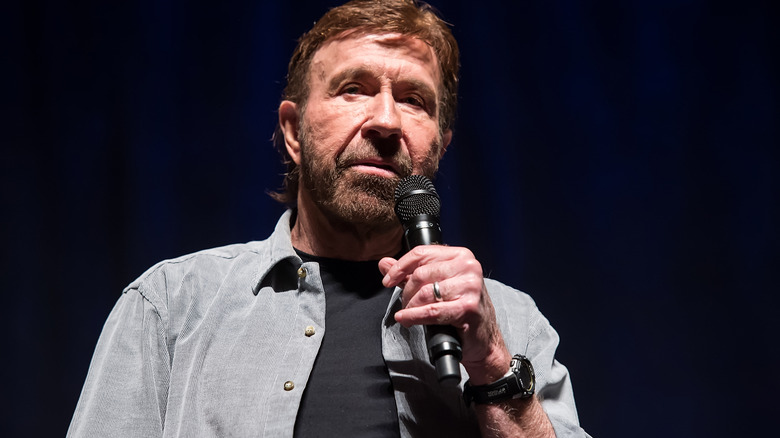 Chuck Norris holding microphone