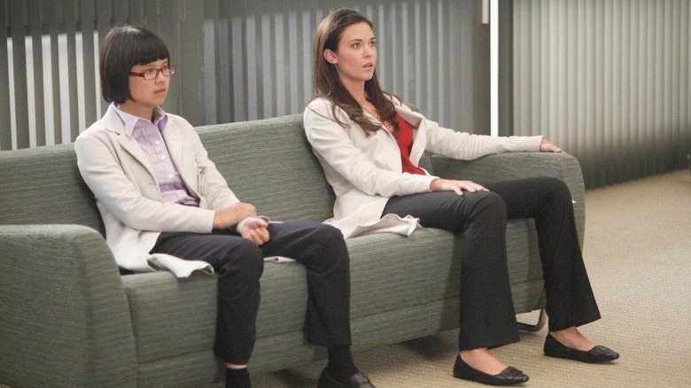 Dr. Park and Dr. Adams sit on a sofa in "House"