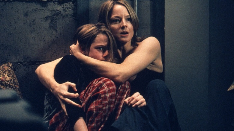 Meg Altman holding Sarah in the panic room