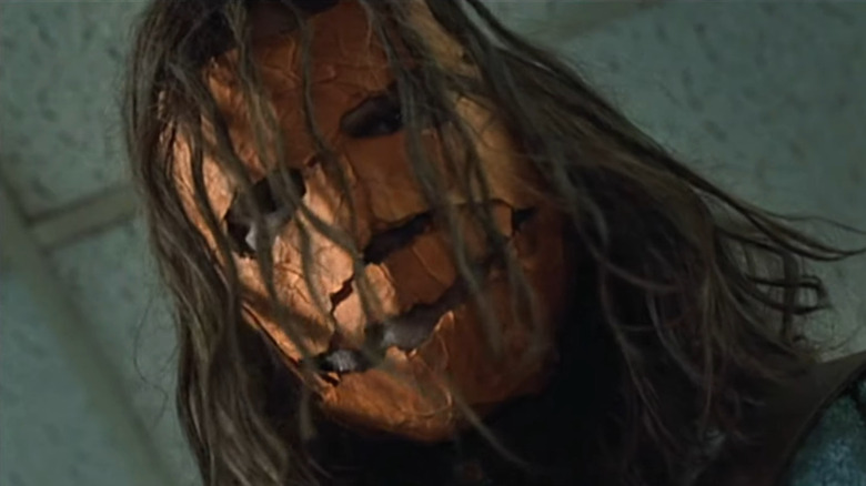 Michael Myers wearing a pumpkin mask