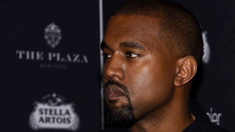 Kanye West looking dour at a press event