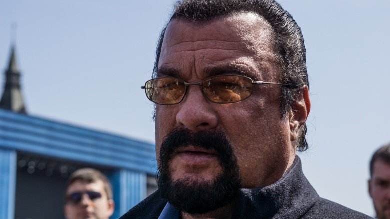 Steven Seagal wearing yellow, reflective sunglasses