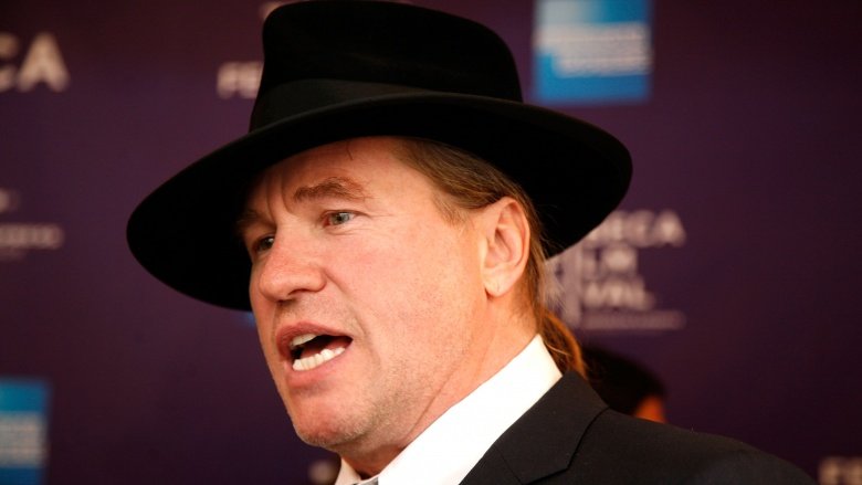 Val Kilmer in a hat at a press event