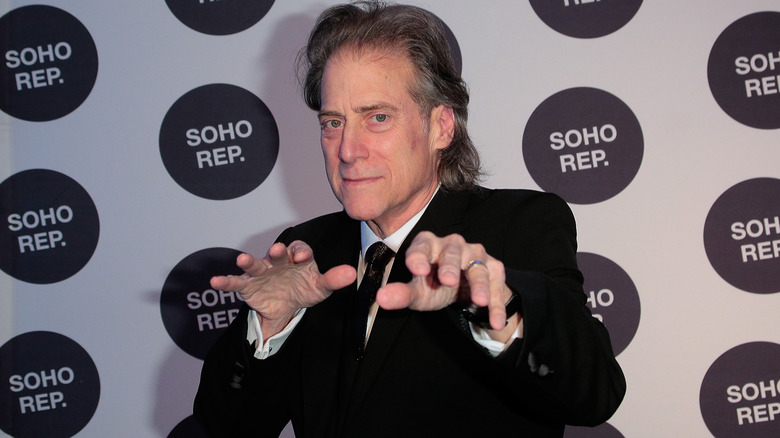 Richard Lewis holds out his hands