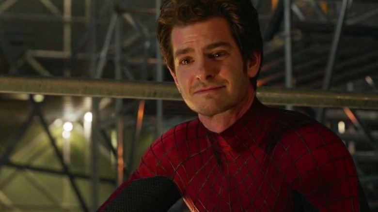 Spider-Man crouches, smiling